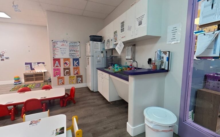 Classroom kitchen and family-style meal tables at Kids Inc.