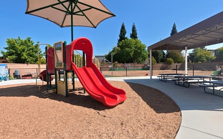 Shaded outdoor play structure at Kids Inc. Preschool Folsom