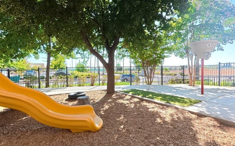 Tree-shaded playground at Kids Inc. Palladio campus