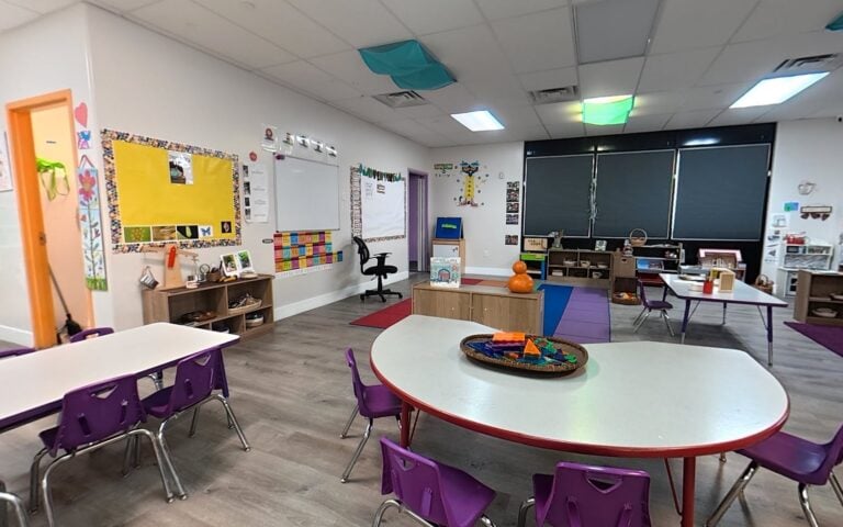 Preschool classroom with circle-time rug at Kids Inc.